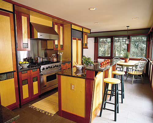 <p>Handsome custom cabinets made from maple, mahogany, and ebonized walnut conceal the fridge, cooking supplies, even a TV. The dual-height island serves as both a breakfast bar and a food prep area.</p>