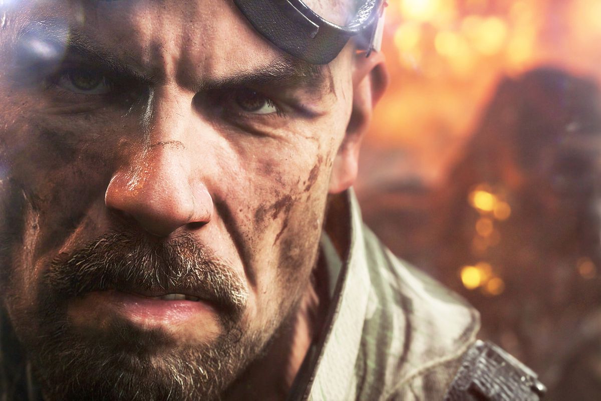 Battlefield 5 - A close-up of a bald soldier with tanker’s goggles, he’s wearing a german Fallschirmjäger pattern camouflage jacket.