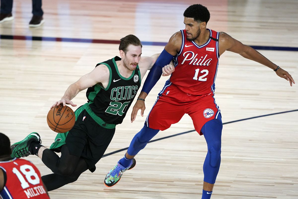 Gordon Hayward of the Boston Celtics drives against Tobias Harris of the Philadelphia 76ers during the first half at The Field House at ESPN Wide World Of Sports Complex on August 17, 2020 in Lake Buena Vista, Florida.