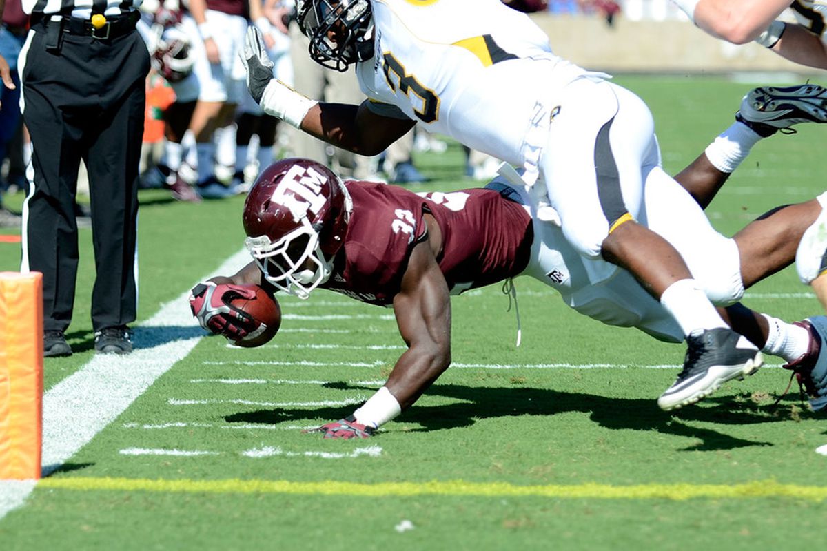 COLLEGE STATION, TX - OCTOBER 29:  Cyrus Gray #32 of the Texas A&M Aggies is tackled on the two yard line during a game against the Missouri Tigers at Kyle Field on October 29, 2011 in College Station, Texas.  (Photo by Sarah Glenn/Getty Images)