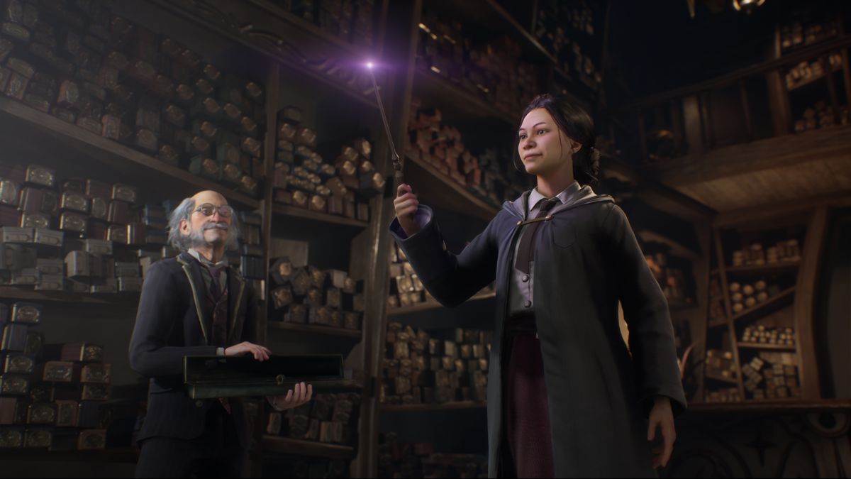 a witch holds her wand, whose tip is glowing purple, at Ollivanders wand shop as an old man looks on in Hogwarts Legacy