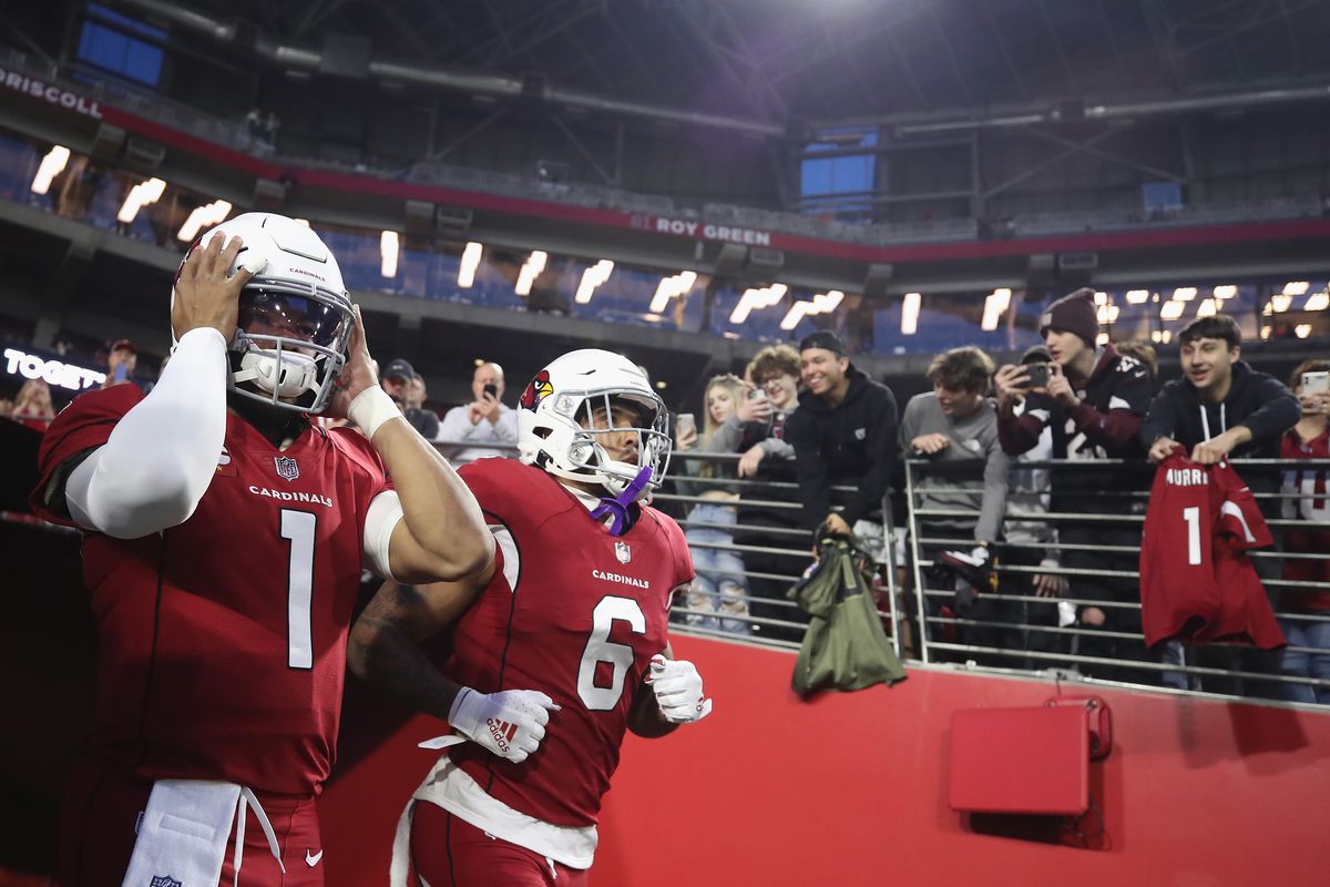 Quarterback Kyler Murray #1 and running back James Conner #6 of the Arizona Cardinals take the field before the NFL game at State Farm Stadium on December 13, 2021 in Glendale, Arizona. The Rams defeated the Cardinals 30-23.