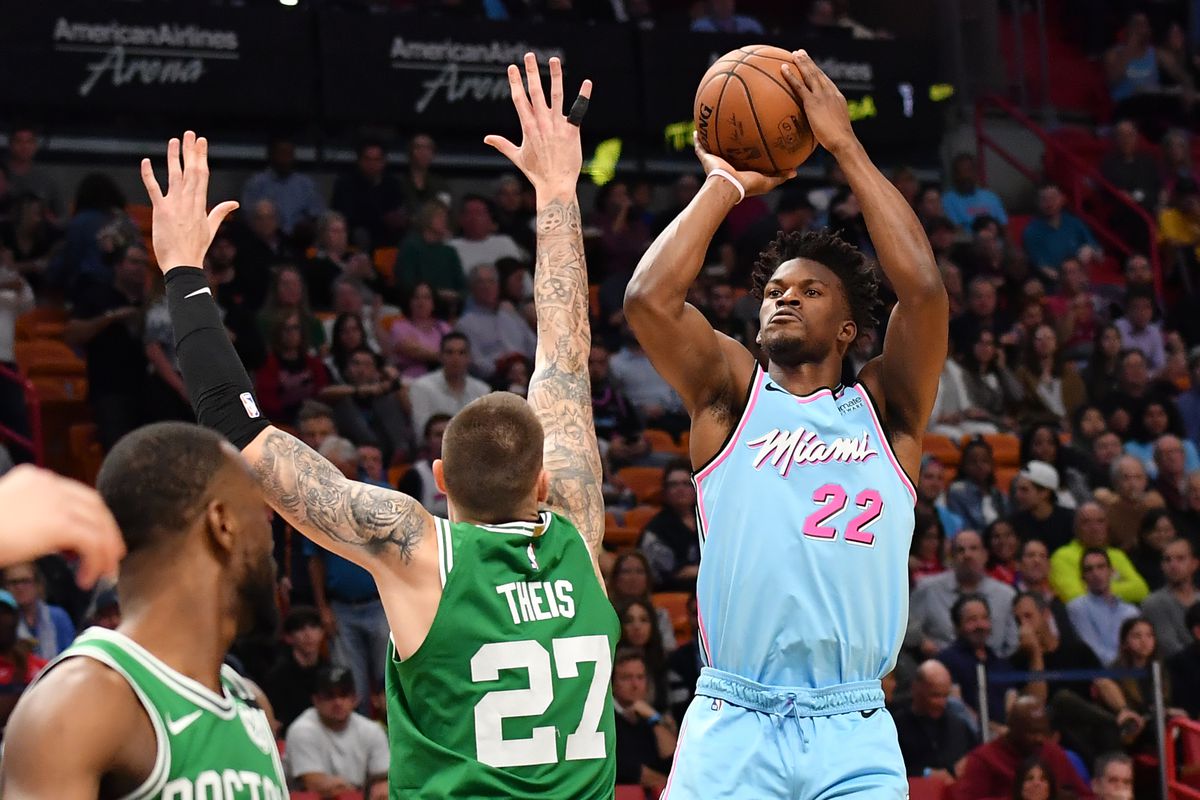 Miami Heat forward Jimmy Butler shoots over Boston Celtics center Daniel Theis during the first half at American Airlines Arena.