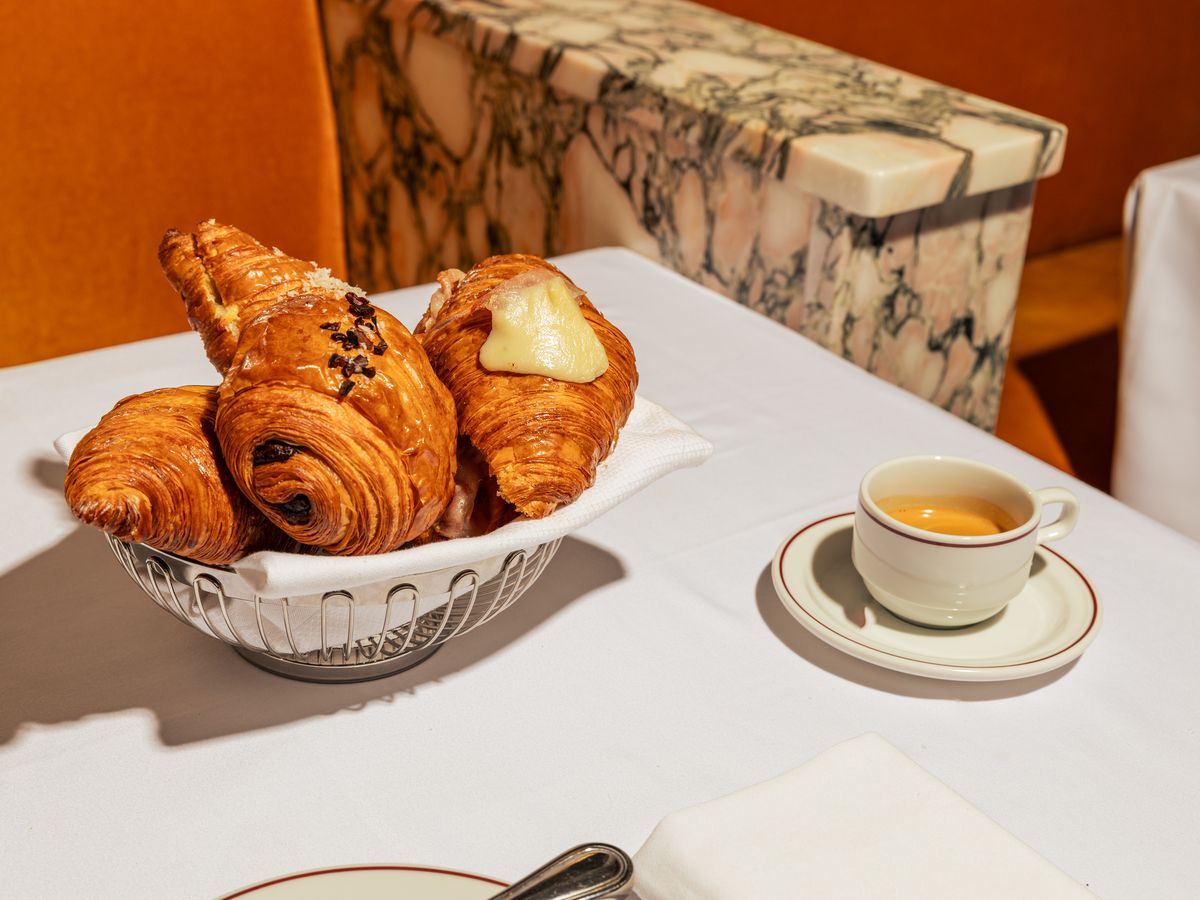 A table with croissants and a cup of espresso.