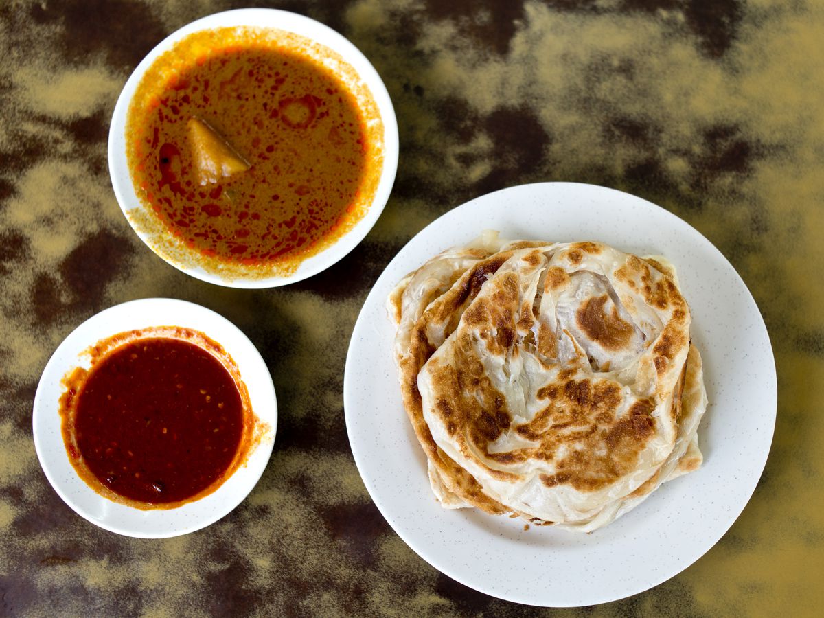 From above, roti with dipping sauces. 