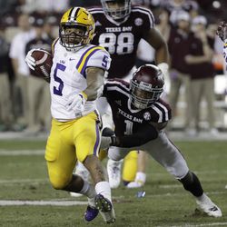 LSU running back Derrius Guice (5) breaks away from Texas A&M defensive back Nick Harvey (1) as he runs for a touchdown during the first quarter of an NCAA college football game Thursday, Nov. 24, 2016, in College Station, Texas. 