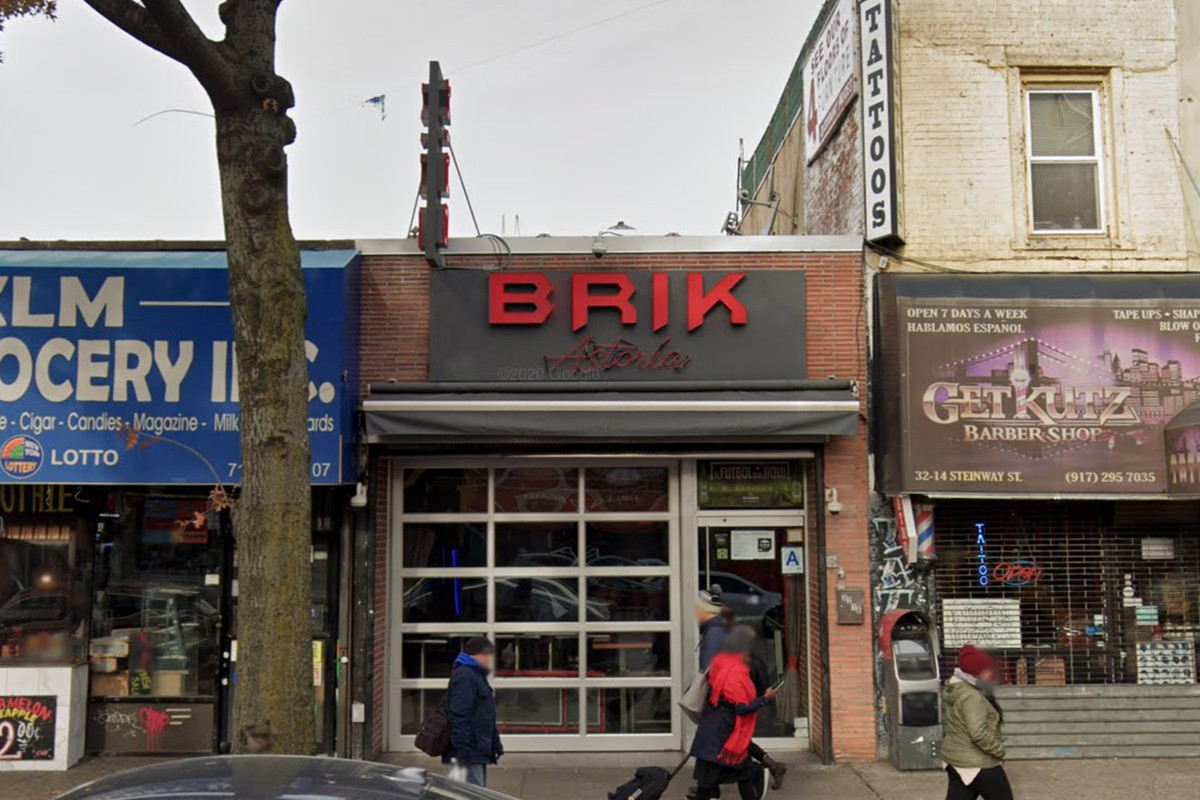 The exterior of a building with a sign in red that reads the Brik