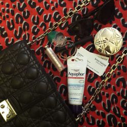 What's in my purse? Not a whole lot—most of my purses are really small. My essentials are <b>Aquaphor</b>, <b>Dior</b> Addict Lip Glow, <b>Nars</b> Velvet Lip Gloss in Mexican Rose, <b>Rohto</b> Cool Eye Drops (a favorite of makeup artist and friend <b>Sh