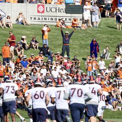 Broncos players receive a warm welcome from the fans as they come together for stretches.