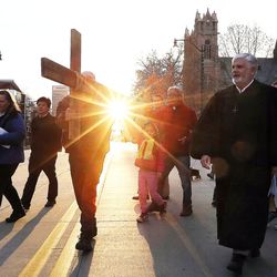 Alex Bury, left, Juliana Snow and Rev. Eun-sang Lee of the First United Methodist Church carry the cross as it leaves the First Presbyterian Church during the Good Friday Procession of the Cross in Salt Lake City, Friday, March 25, 2016. At right is Rev Michael Imperiale of the First Presbyterian Church.