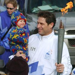Steve Young holds his son at the start of his torch run February 8, 2002.