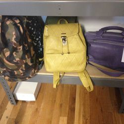 Cooper camouflage duffel, $380; yellow backpack, $290; purple purse, $325  