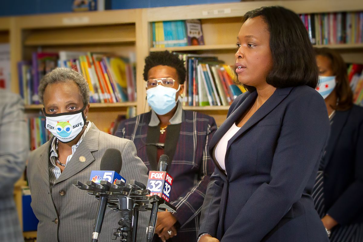 Mayor Lori Lightfoot and school chief Janice Jackson standing by a microphone.