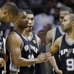 The San Antonio Spurs' Tony Parker (9) Gary Neal (14) and Tim Duncan (21) speak in the closing seconds of the second half in Game 7 of the NBA basketball championship against the Miami Heat, Thursday, June 20, 2013, in Miami. The Miami Heat won 95-88. 