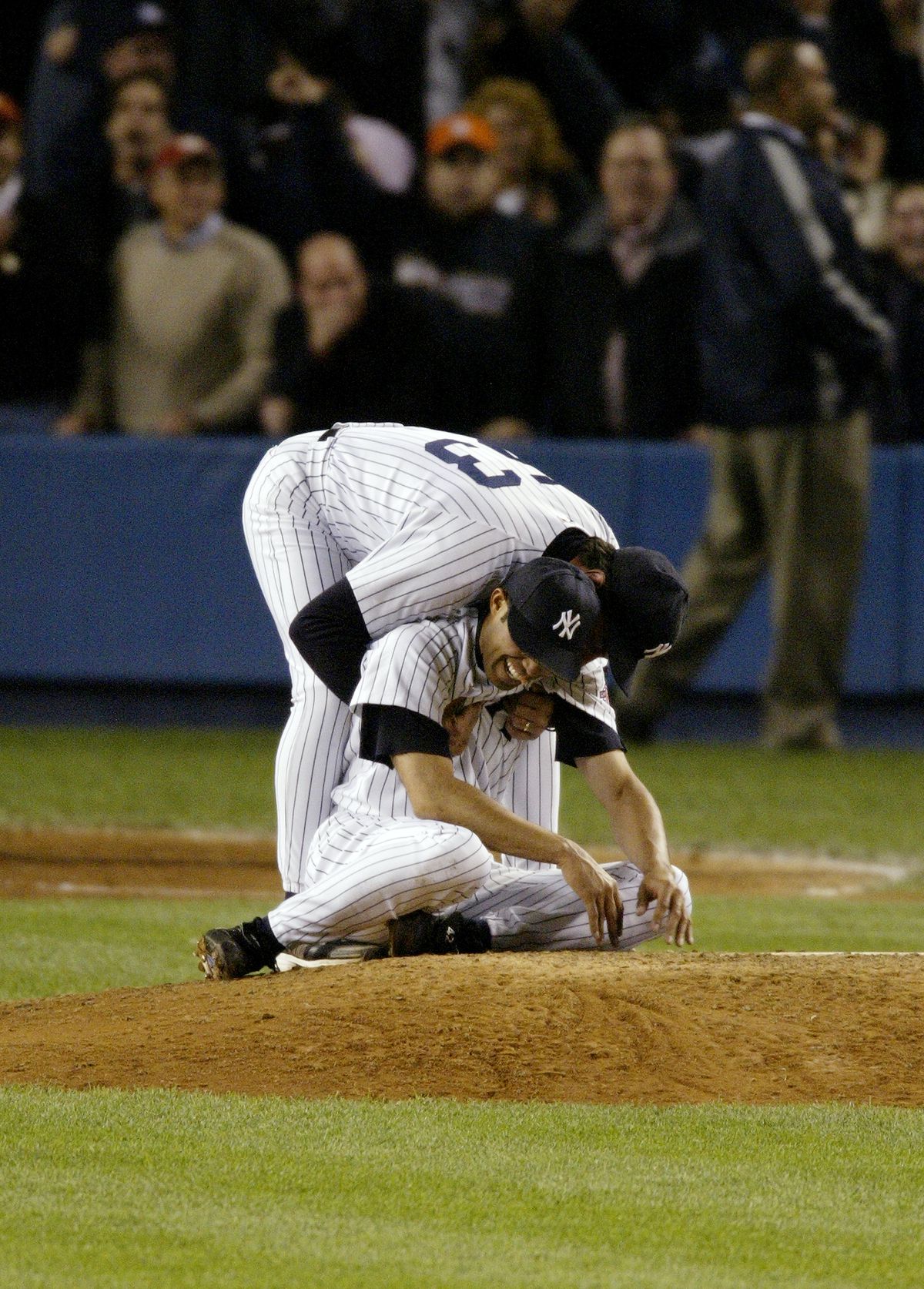 New York Yankees’ first base coach Lee Mazzilli hugs Mariano