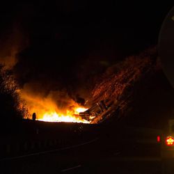 A double tanker truck loaded with crude oil rolled on US-40 Friday night in Daniels Canyon, spilling its load and catching fire, according to the Utah Highway Patrol.