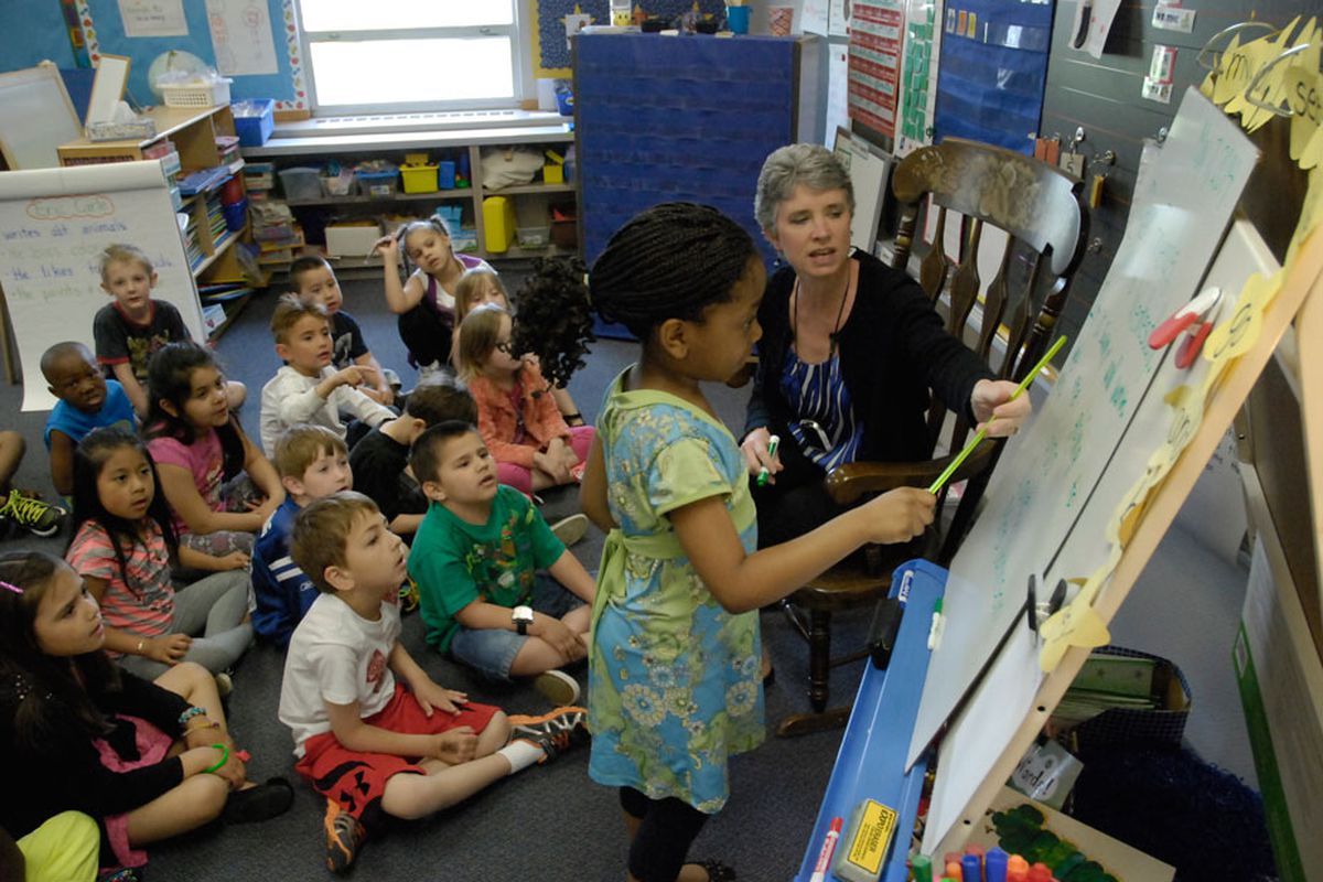 A teacher helps a student during classroom instruction at McClelland Elementary School.