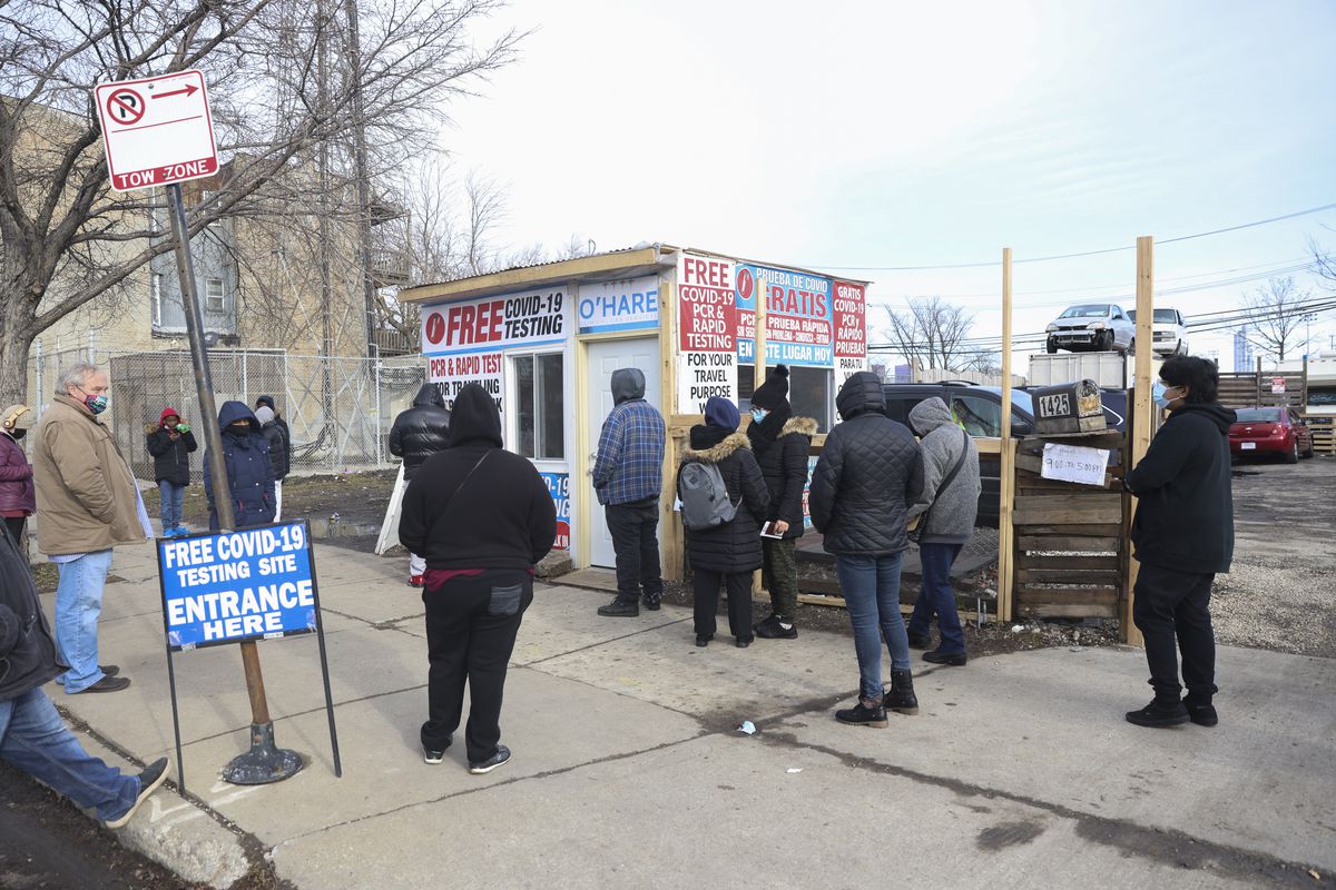 People wait in line for a COVID-19 test at 1425 S Ashland Ave in University Village, Wednesday, Dec. 29, 2021.