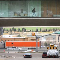 An Adobe employee walks through the office as traffic moves below in Lehi Wednesday, March 23, 2016.  Several counties and cities in Utah were among the fastest growing in the nation last year, according to new data from the U.S. Census Bureau.