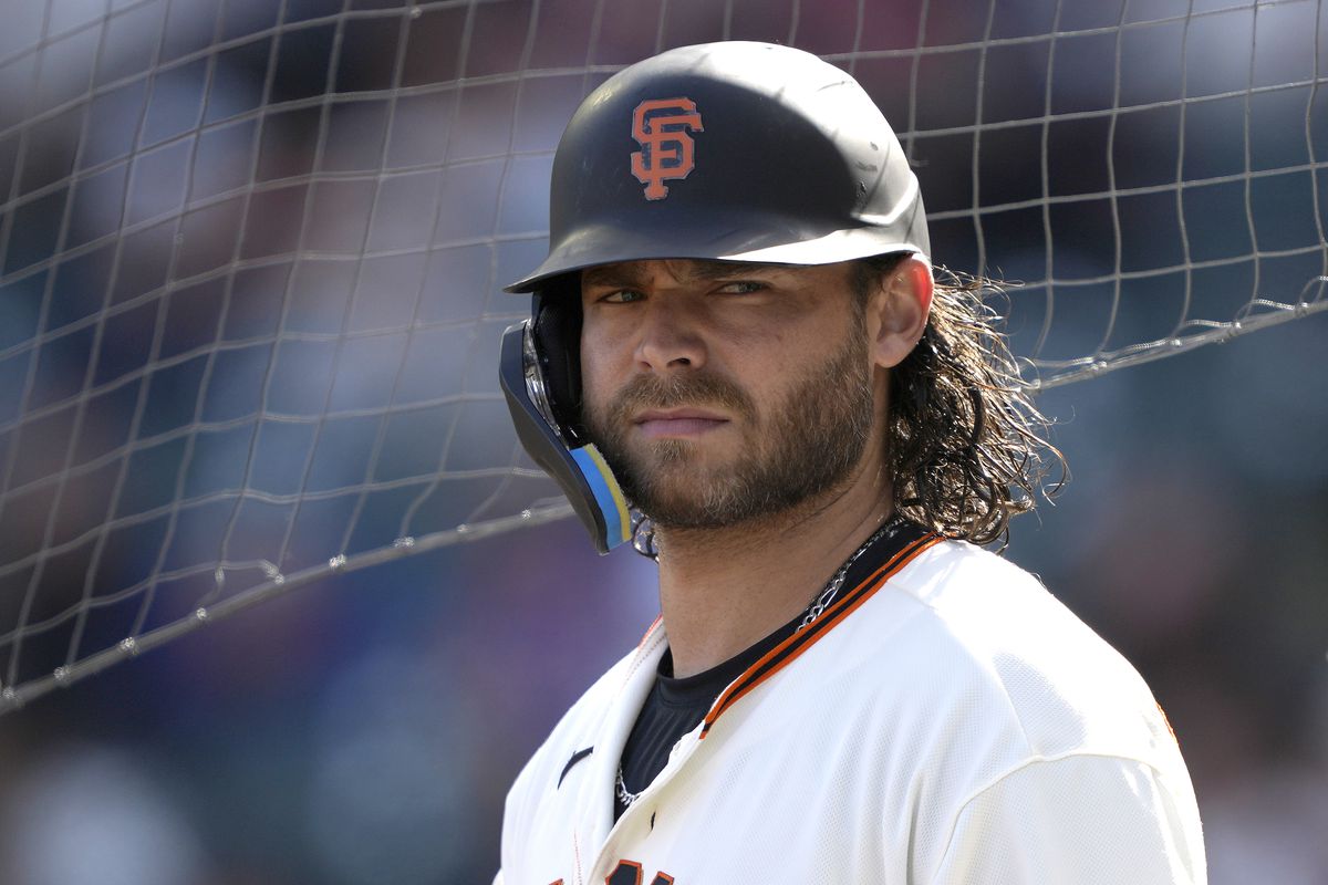 Brandon Crawford looking over his shoulder with his batting helmet on