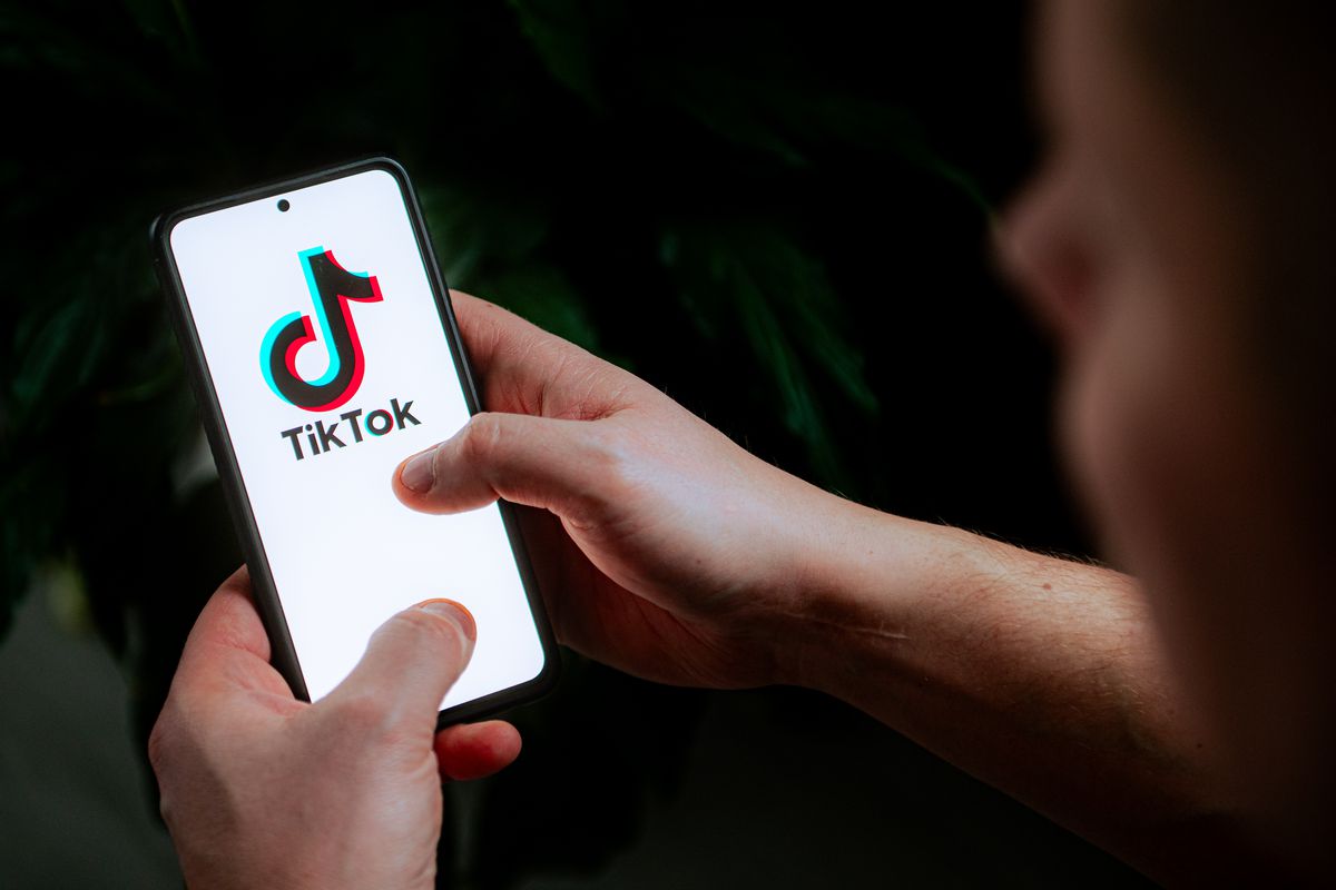 A photo illustration showing a TikTok logo displayed on a cell phone.