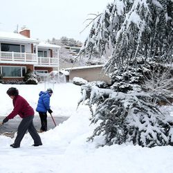 Amanda and Larry Barusch shovel their driveway and sidewalk in the Avenues of Salt Lake City on Thursday, Jan. 5, 2017.