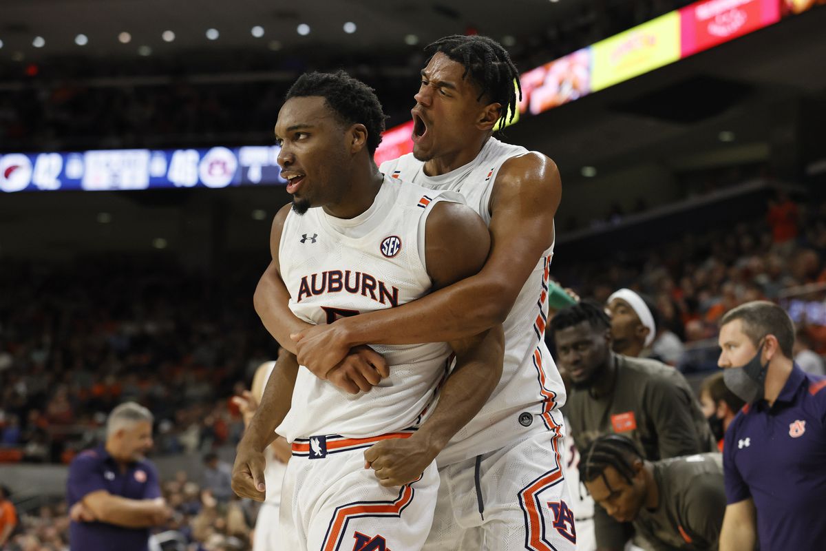 Auburn Tigers forward Chris Moore is hugged by center Dylan Cardwell after making a shot against the Louisiana Monroe Warhawks at Auburn Arena.