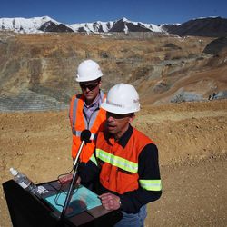 Kelly Sanders, front, president and CEO of Rio Tinto's Kennecott Utah Copper, speaks to the media during a tour of the Bingham Canyon Mine on Thursday, April 25, 2013. At back is Salt Lake County Mayor Ben McAdams.