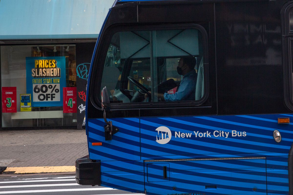 An MTA bus heads past signs of struggling businesses along Harlem’s 125th Street, Dec. 1, 2020.