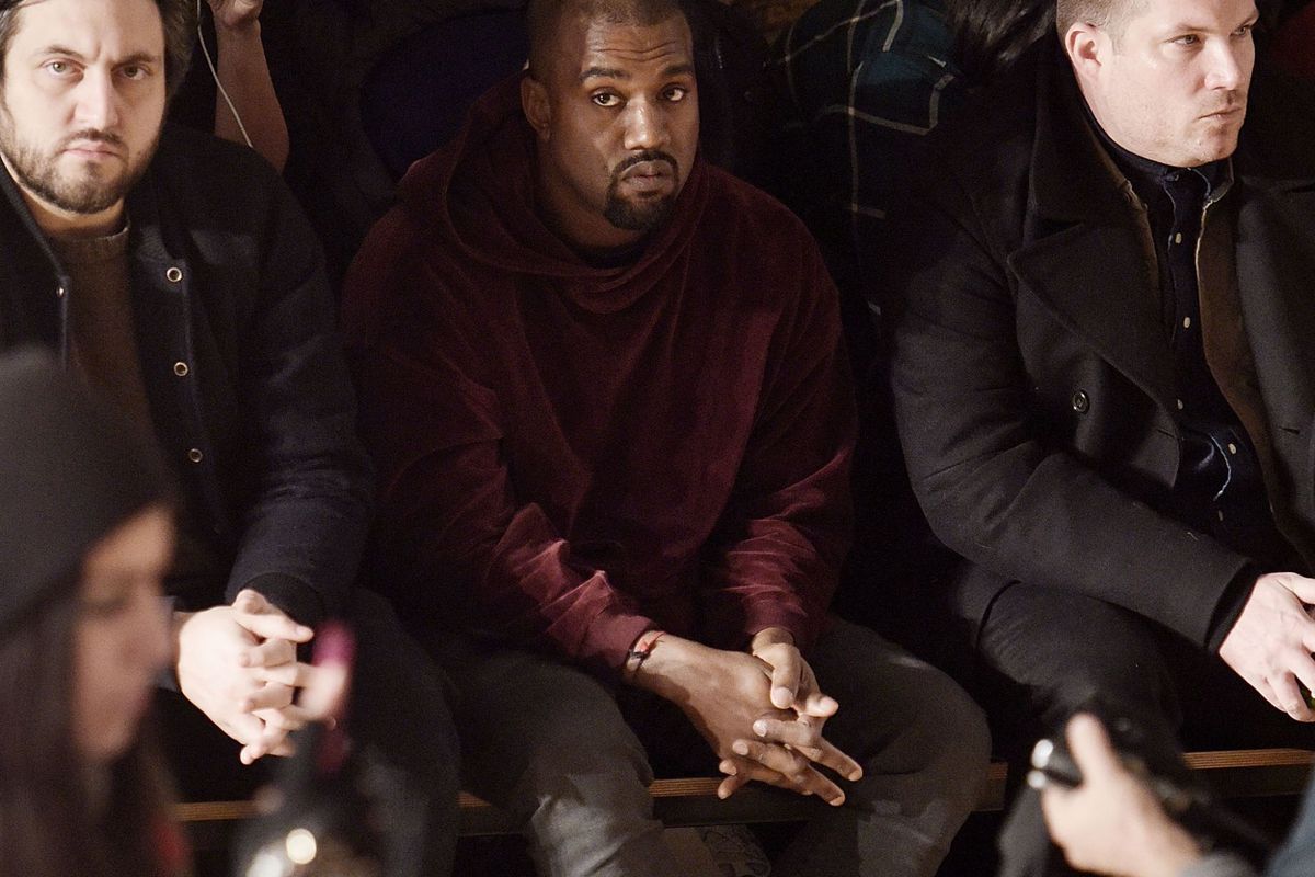 Kanye West, struggling to enjoy a fashion show. (Grant Lamos IV/Getty Images) 