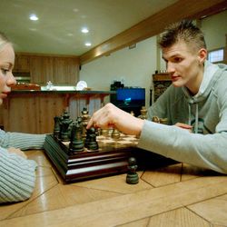Jazz rookie forward Andrei Kirilenko and wife Masha Kirilenko enjoy a game of chess in their Salt Lake City home in 2001.