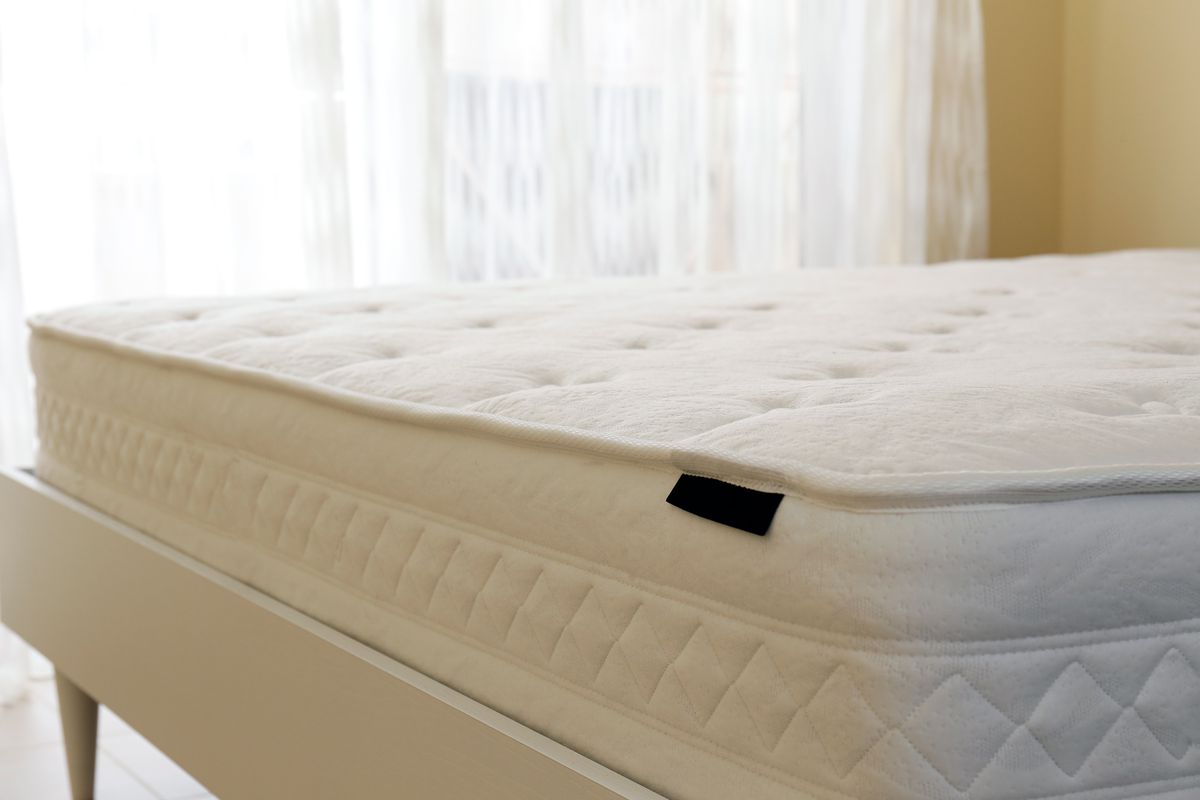 A clean mattress with no sheets. 