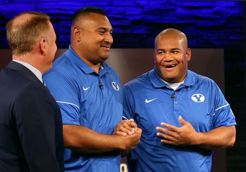 Kalani Sitake, head coach, and Ilaisa Tuiaki, BYU defensive coordinator and defensive line coach, shake hands during BYU media day at BYU Broadcasting in Provo on Friday, June 23, 2017.