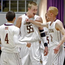 Lone Peak's Nick Emery (4), Eric Mika (55) and T.J. Haws (11) celebrate as Lone Peak High School defeats Davis High School in the state 5A quarterfinals basketball tournament Wednesday, Feb. 27, 2013, in Ogden.