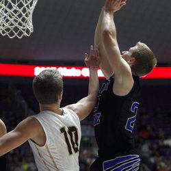 Pleasant Grove's Daniel Diehl (20) shoots against Davis' Jesse Wade (10) as Davis plays Pleasant Grove in the 5A boys basketball quarterfinals at the Dee Events Center in Ogden Wednesday, Feb. 25, 2015.