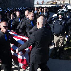 Pallbearers move the casket to the waiting hearse following funeral services for West Valley police officer Cody Brotherson at the Maverik Center in West Valley City on Monday, Nov. 14, 2016.
