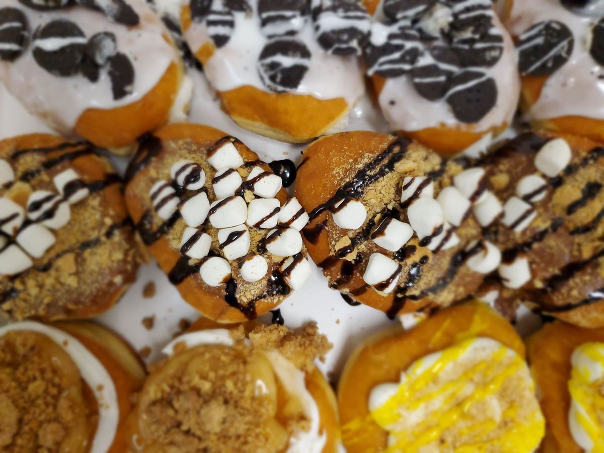 Kosher Gourmet in Atlanta offers batches and individual sufganiyot for sale in flavors like classic jelly, cookies and cream, s’mores, and rainbow berry during Hanukkah. 