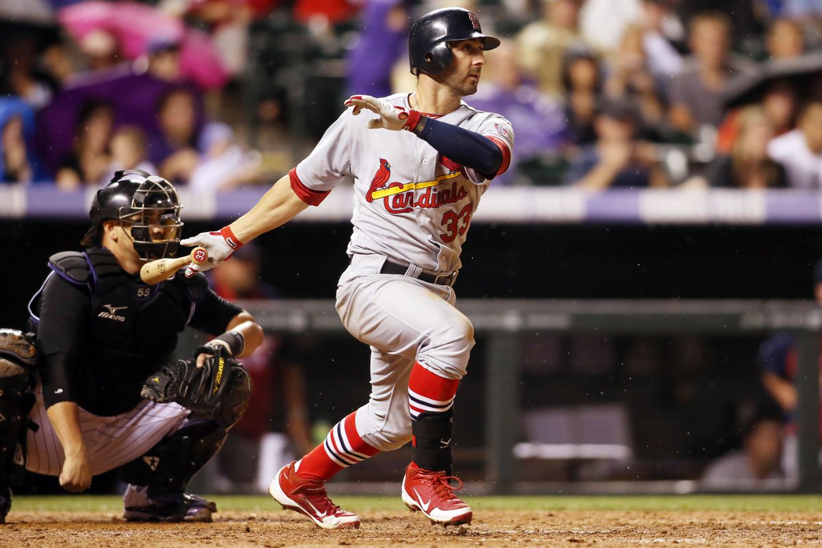 August 1, 2012; Denver, CO, USA; St. Louis Cardinals shortstop Daniel Descalso (33) hits a single during the seventh inning against the Colorado Rockies at Coors Field.  Mandatory Credit: Chris Humphreys-US PRESSWIRE