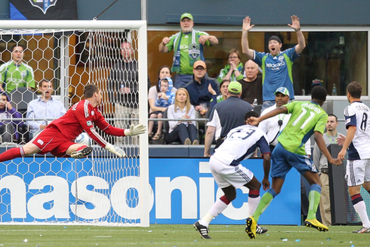 SEATTLE - JUNE 05:  Steve Zakuani #11 of the Seattle Sounders FC scores against goalkeeper Bobby Shuttleworth #34 of the New England Revolution on June 5, 2010 at Qwest Field in Seattle, Washington. (Photo by Otto Greule Jr/Getty Images)
