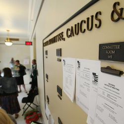 People gather prior to a Republican House Caucus meeting to discuss the possibility of impeachment proceedings for Attorney General John Swallow at the Capitol in Salt Lake City Wednesday, June 19, 2013.