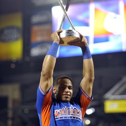 American League player Yoenis Cespedes of the Oakland Athletics poses with the trophy after winning the Home Run Derby.