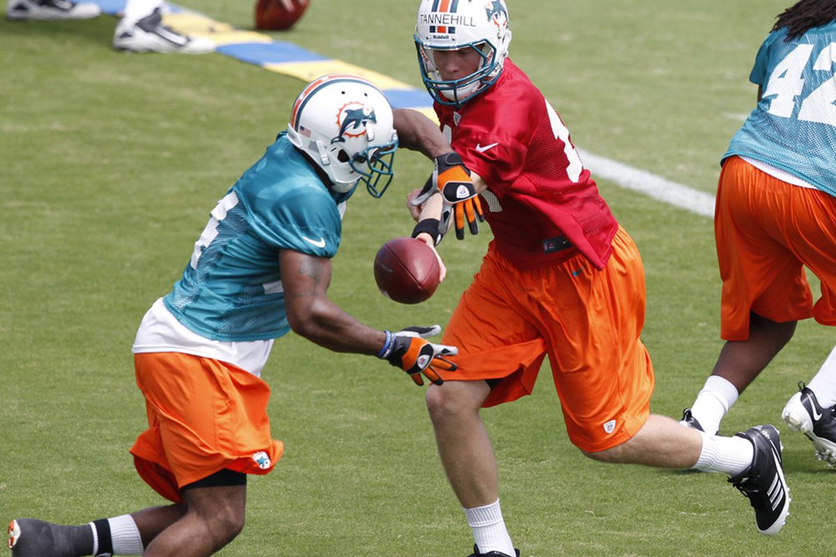 DAVIE, FL - MAY 4:  Ryan Tannehill #17 hands the ball off to Marcus Thigpen #34 of the Miami Dolphins during the rookie minicamp on May 4, 2012 at the Miami Dolphins training facility in Davie, Florida. (Photo by Joel Auerbach/Getty Images)