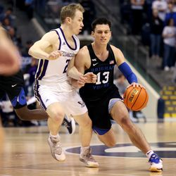 Westminster Griffins guard Matt Kitzman (2) works to stay with Brigham Young Cougars guard Alex Barcello (13) as BYU and Westminister play at the Marriott Center in Provo on Wednesday, Dec. 29, 2021. BYU won 65-53.