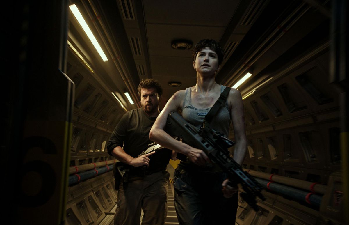 Danny McBride backs up Katherine Waterston as they battle an alien.
