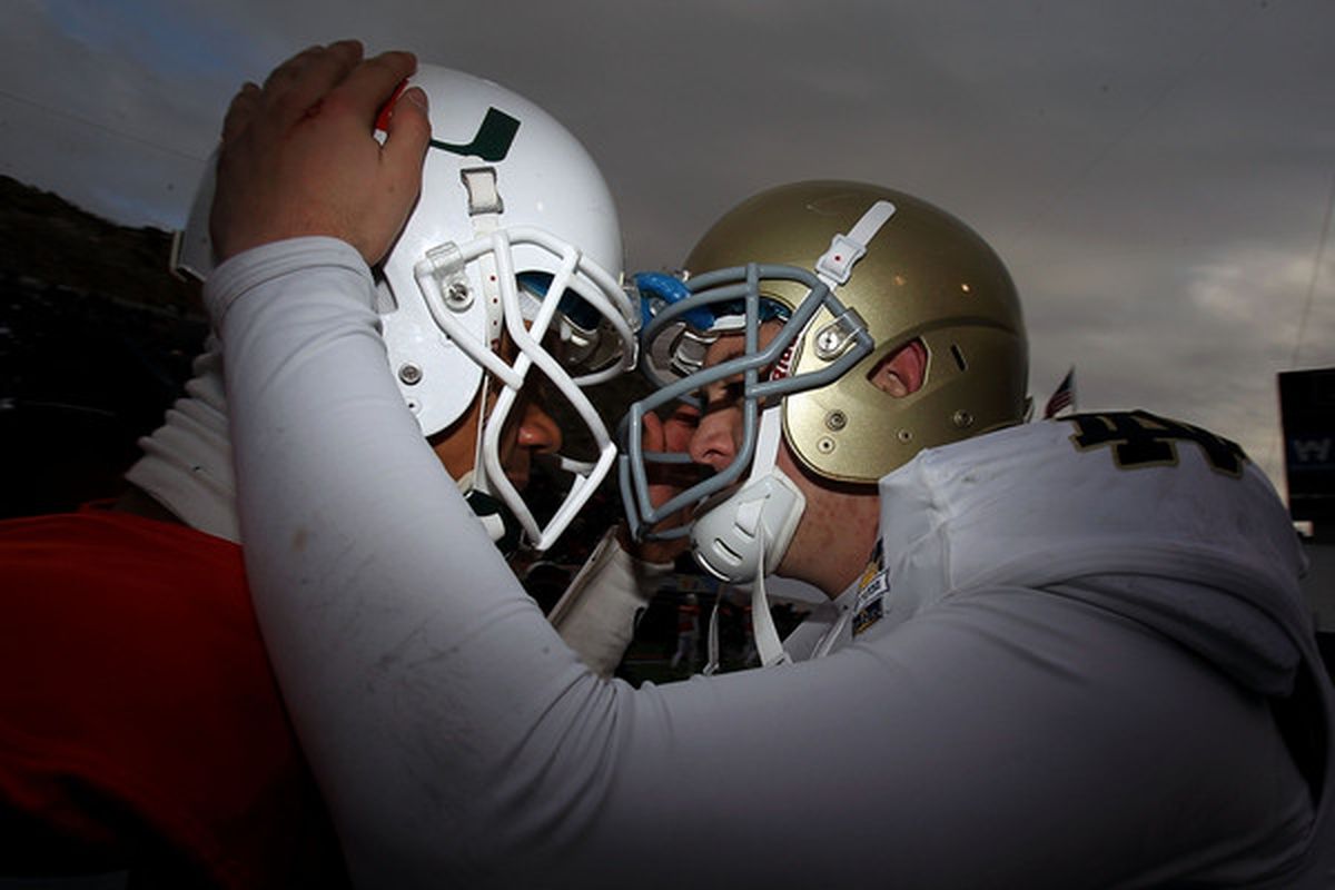 EL PASO TX - DECEMBER 30:  (L-R) Stephen Morris #17  of the Miami Hurricanes hugs Tommy Rees #13 of the Notre Dame Fighting Irish at Sun Bowl on December 30 2010 in El Paso Texas.  (Photo by Ronald Martinez/Getty Images)