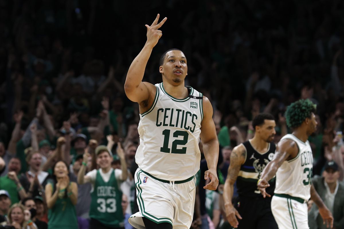 Boston Celtics forward Grant Williams (12) celebrates after making a three point basket against the Milwaukee Bucks during the second half of game seven of the second round of the 2022 NBA playoffs at TD Garden.