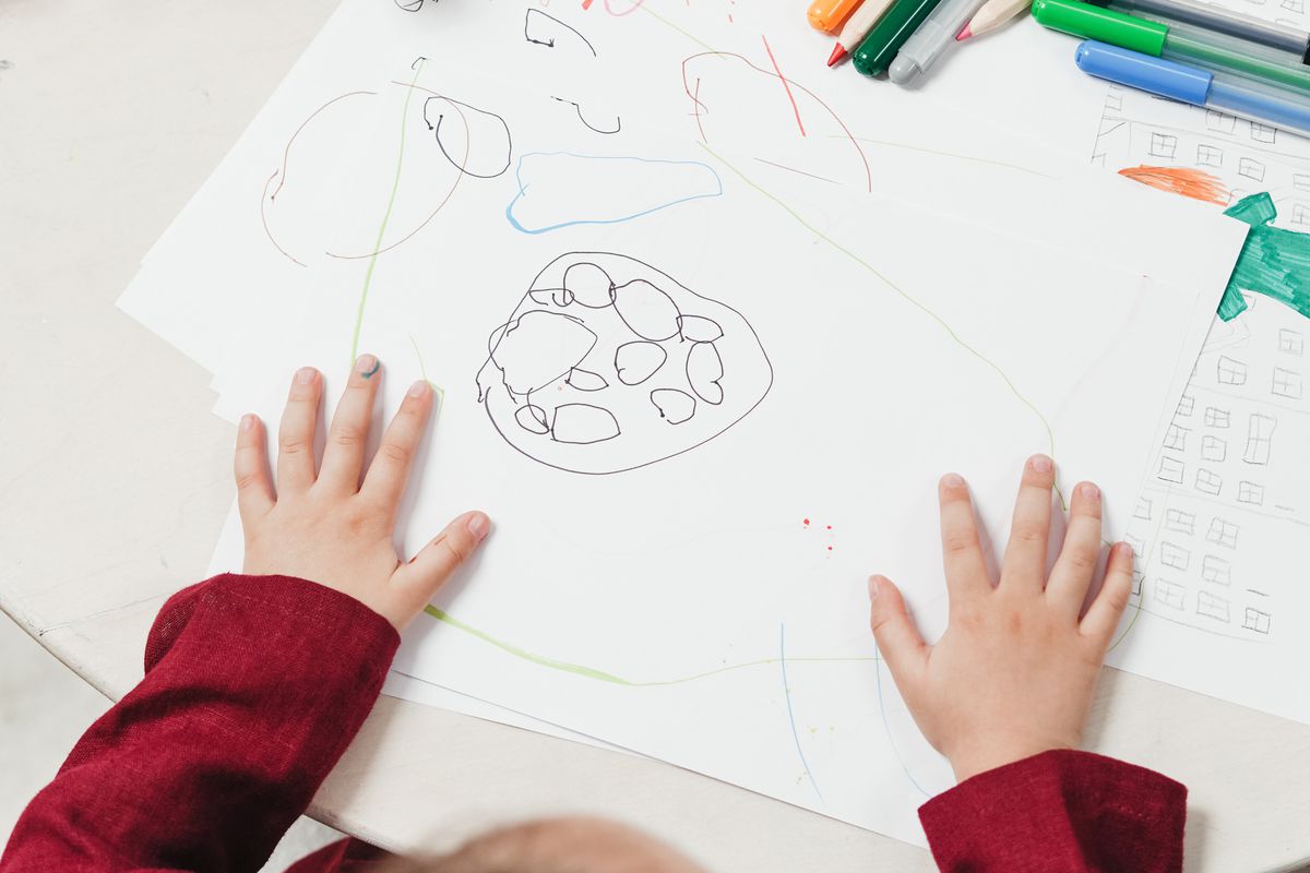 High angle photo of a child drawing.