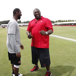 Jul 25, 2013; Tampa, FL, USA; Tampa Bay Buccaneers cornerback Darrelle Revis (24) laughs with NFL Network analyst Warren Sapp after training camp at One Buccaneer Place. Mandatory Credit: Kim Klement-USA TODAY Sports