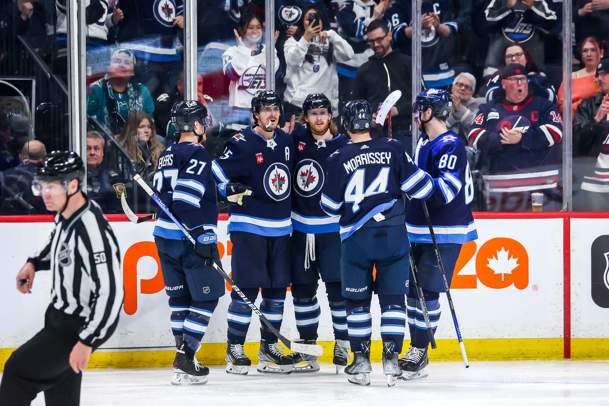 Nikolaj Ehlers #27, Mark Scheifele #55, Kyle Connor #81, Josh Morrissey #44 and Pierre-Luc Dubois #80 of the Winnipeg Jets celebrate a third period goal against the San Jose Sharks at the Canada Life Centre on April 10, 2023 in Winnipeg, Manitoba, Canada.