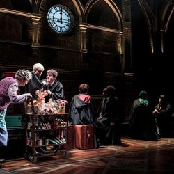 The Trolley Witch (Sandy McDade) offers sweets to Scorpius (Anthony Boyle) and Albus (Sam Clemmett) on the Hogwarts train in "Harry Potter and the Cursed Child," in London at the Palace Theatre.